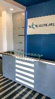 The reception table.

Being a pharmaceutical unit, we were asked not to use wood, plywood and other wood based material for the work. This table therefore has been made of stainless steel, glass and solid surfacing material.